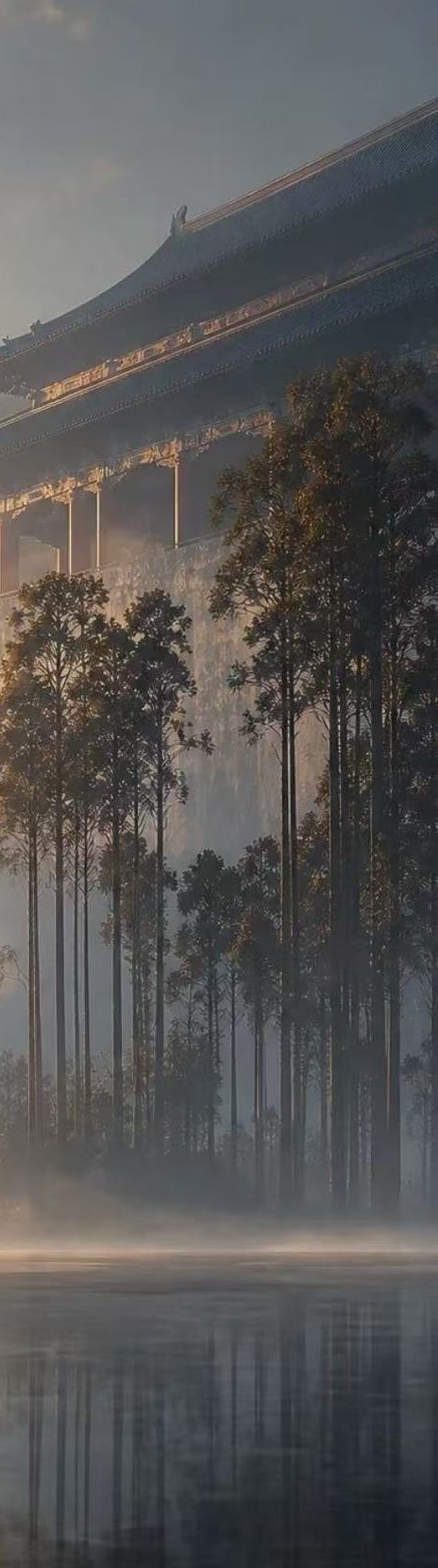 Misty temple roof and pines over water