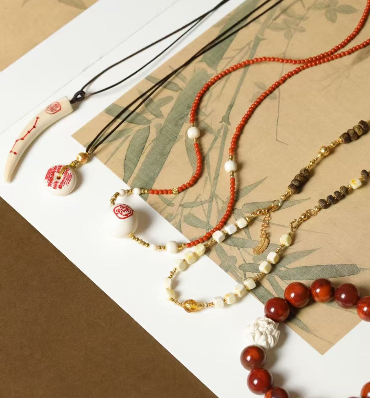 Guardian tusk and coin necklace on red string